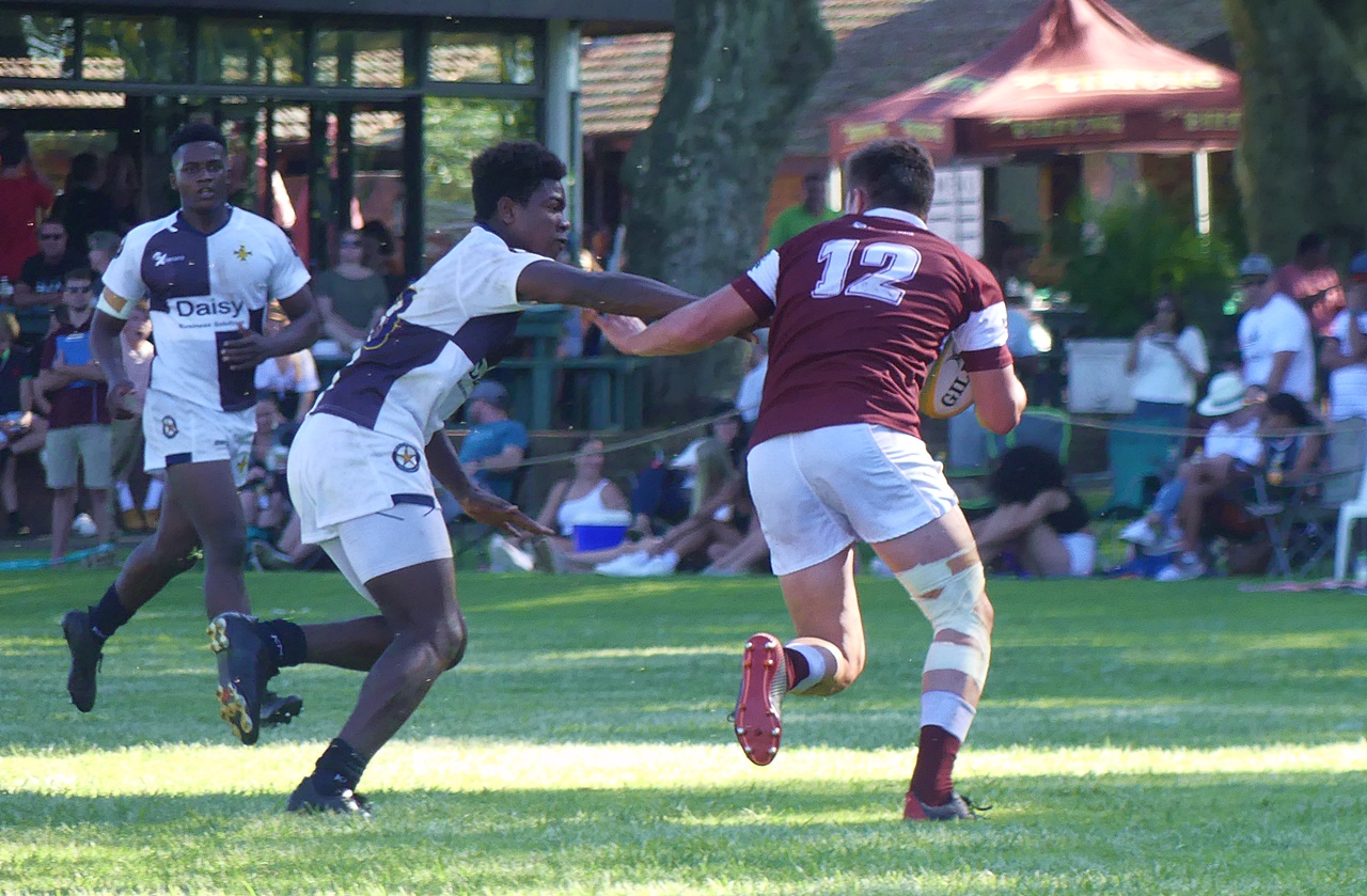 Kearsney centre Connor de Bruyn attempts to fight off a tackle from Northwood flyhalf Emmanuel Bhiya.