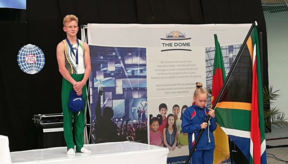 Luke James on the podium after finishing in third place on the floor in the African Junior Championships, held in Swakopmund, Namibia, in 2018. (Photo: South African Gymnastics Federation, http://www.sagf.co.za/)