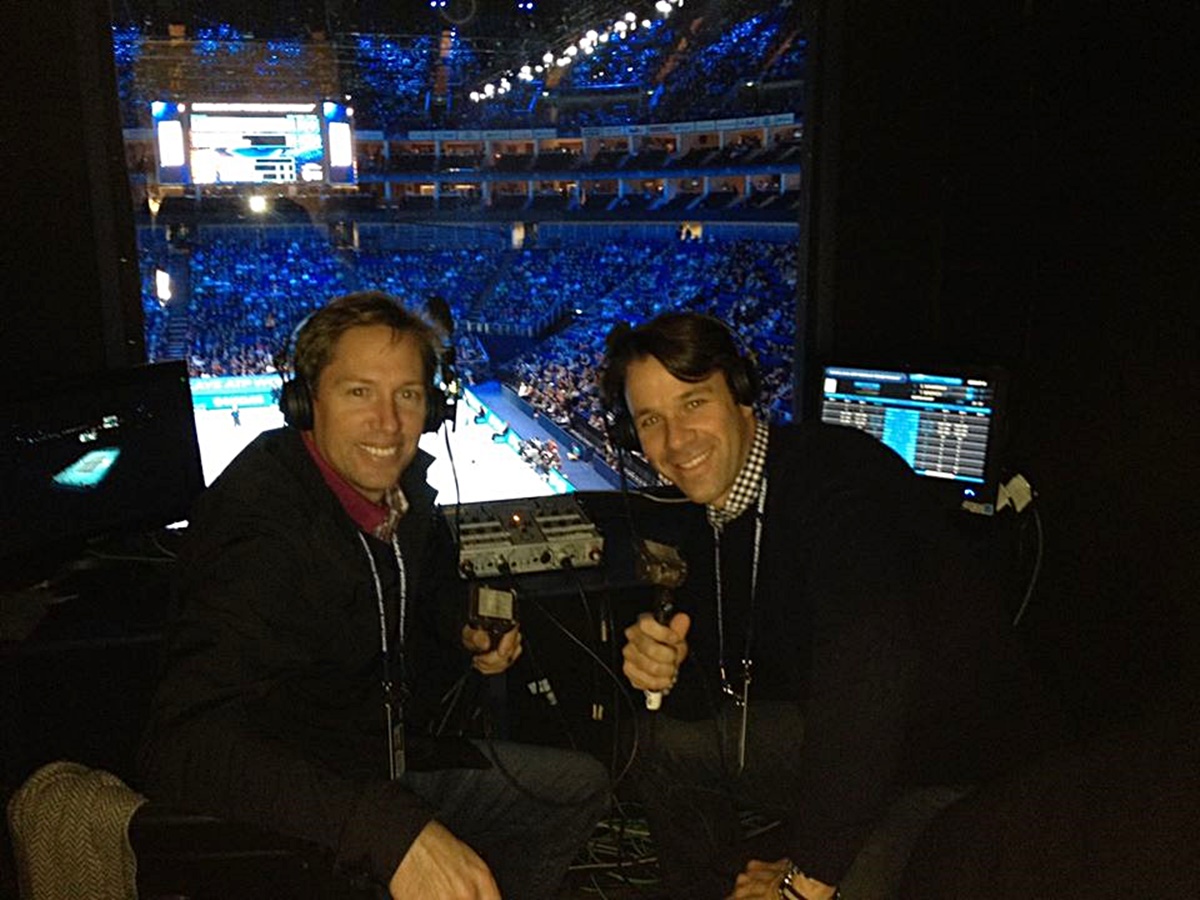 Robbie showing Andrew Rueb, a former doubles’ partner and current coach of the Harvard men’s tennis team, the booth at the ATP World Tour finals in London in 2014.