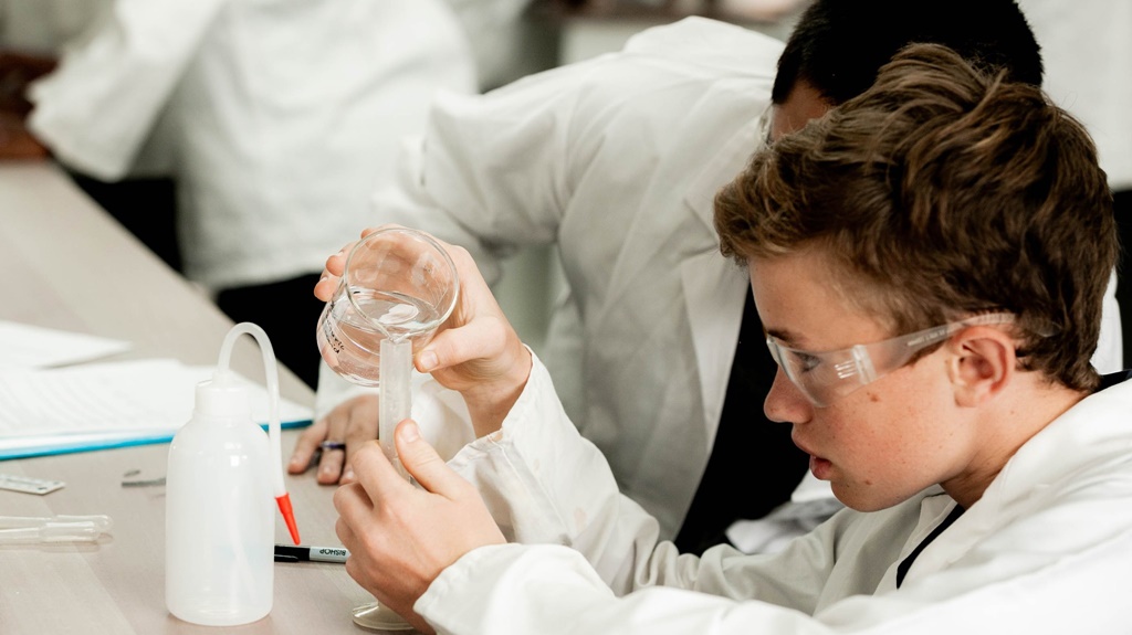 Deep in concentration, a Saints' boy enjoys the beautifully-equipped new science laboratory.