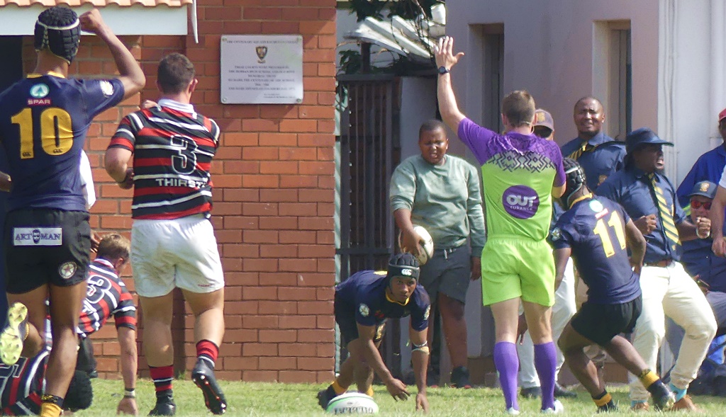 Scrumhalf Florenson Ockhuis rises from the ground after scoring a second DHS try, as, around him, the home supporters cheer. (Photo: Brad Morgan)