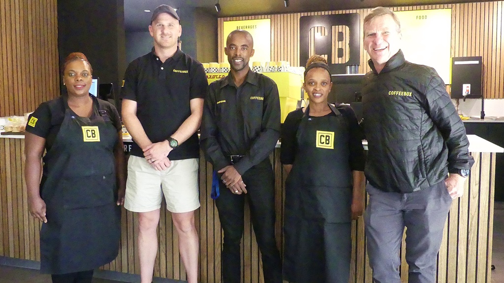 Mark Malherbe (second from left) and his dad, Con (right), with some of the staff of Maritzburg College's Coffeebox. (Photo: Brad Morgan)