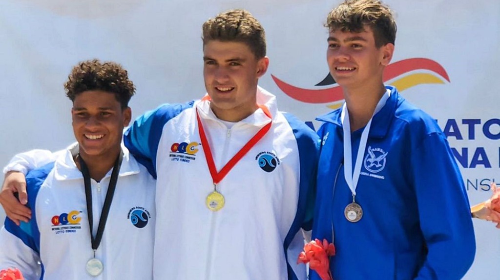 Damien celebrates winning the CANA Zone IV 5km open water swimming title for a second year in succession, in Luanda, Angola.