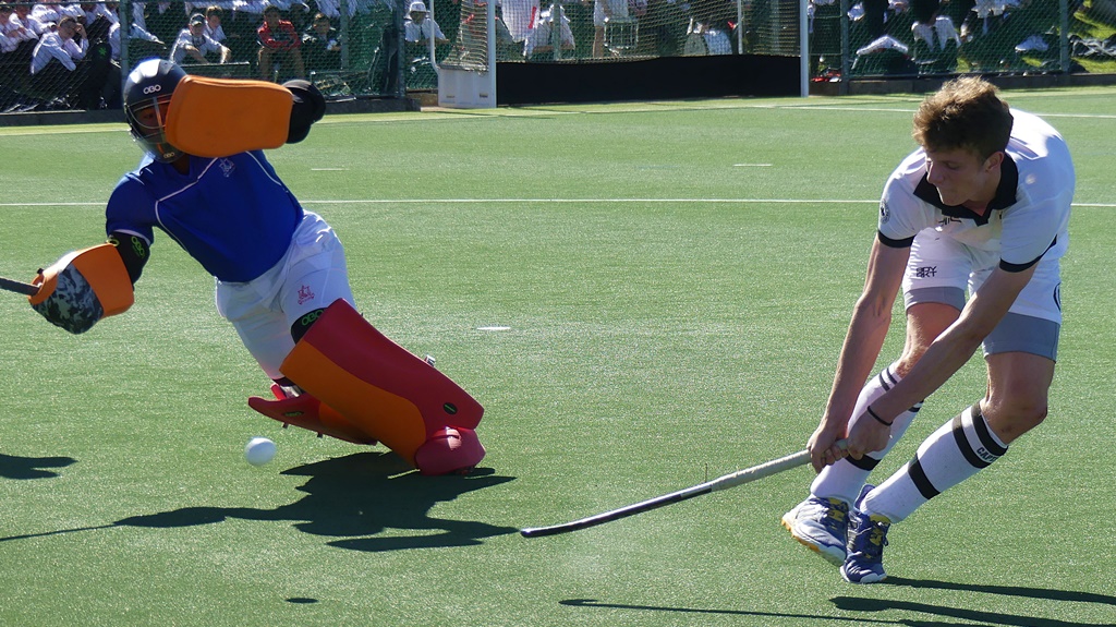 Hilton captain Vian Liebenberg gets off a reverse stick shot under pressure from Michaelhouse goalkeeper Pikolomzi Nkompela. (Photo: Brad Morgan)