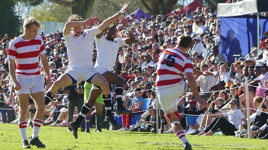 Pressure and intensity was the name of the game. Here, Michaelhouse fullback Murray Baker gets a kick away just in time as two Hilton defenders attempt to charge down his clearance. (Photo: Brad Morgan)