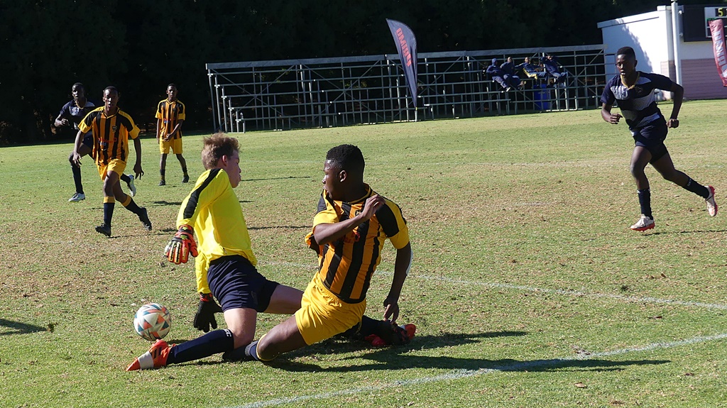 Saints made it tough on DHS, but the boys in yellow finally broke through when they sneaked this shot past the 'keeper. (Photo: Brad Morgan)