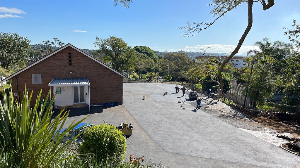 The open area alongside the old gymnasium, which has served as a temporary boarding facility while the new accommodations are being built, has had seating and tables added since this photo was taken, for use by grade 8 boys.