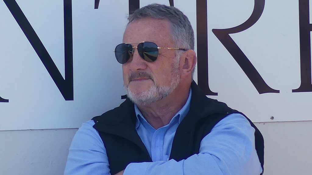 Chris Luman, seated alongside the pool at the Clifton Aquatic Centre, lending his support to Maritzburg College's 1st water polo team at the KZN Top 10 Water Polo Tournament. (Photo: Brad Morgan)