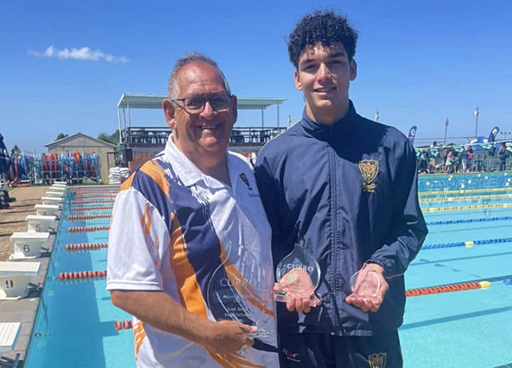 Steve La Marque congratulates Keyontae Raynard on winning the trophy for the best performance of the Curro AquaElite Gala.