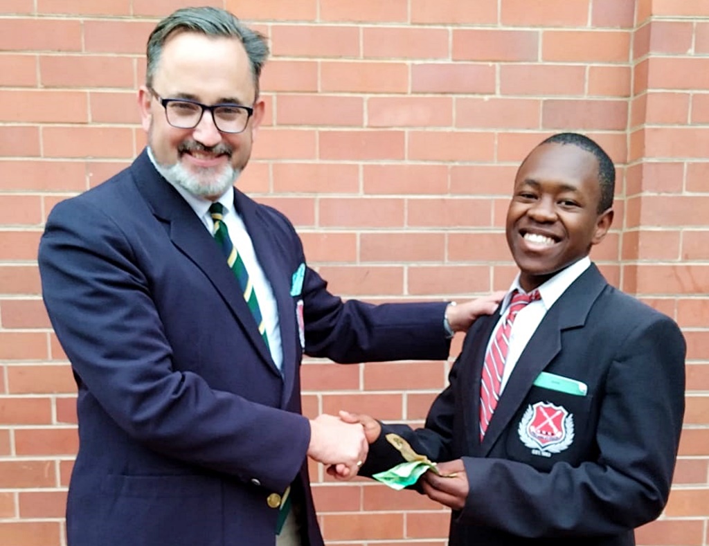 After a successful launch of his car washing business, Lethokuhle Shangase presented Maritzburg College Deputy Headmaster Matthew Marwick with the school's cut of the proceeds following the first week of business.