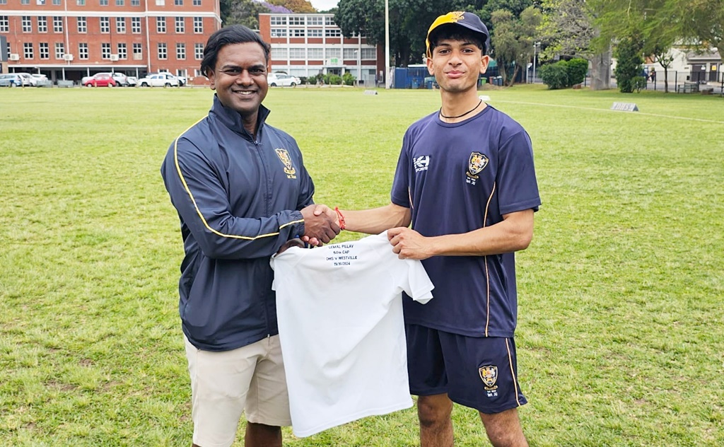 DHS 1st XI coach Fabian Lazarus presented captain Semal Pillay with a special shirt to commemorate his 50th appearance for the 1st XI. Photo: DHS on Facebook.